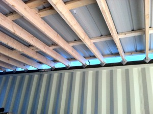 Temporary roof over containers. Makes a bit of a garage to keep whatnot underneath dry. Looks good freshly constructed. 
