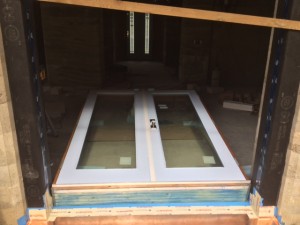 Raising French Doors. Notice the wood to keep the door from falling through. Have to do these things when you work alone.